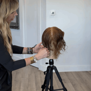 Herta Branding cutting a graduated bob on a mannequin.