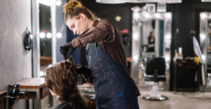 Women Stylist Combing and Cutting Female Client Hair - Stylists Pay Stylists