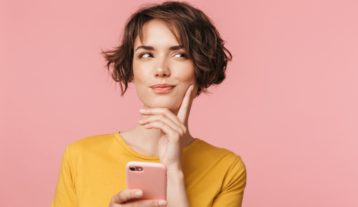 Woman pondering with her cellphone